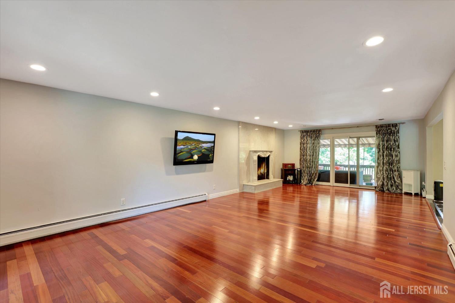 403 New Dover Road Colonia, NJ 07067 - Photo 12 of 51 an empty room with wooden floor and windows