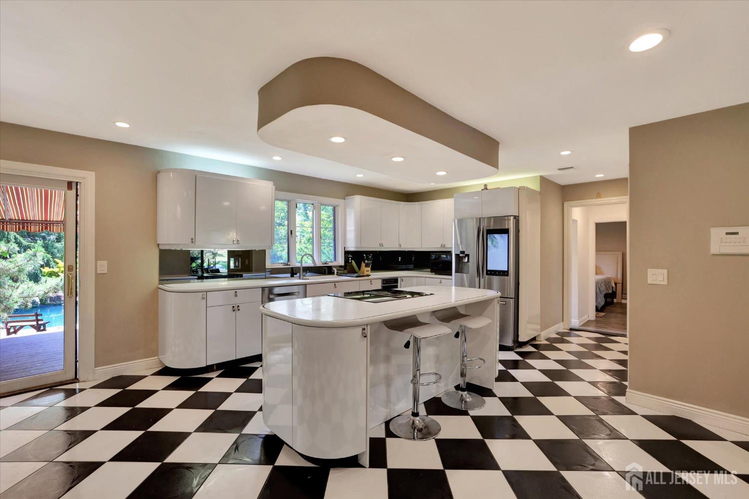 403 New Dover Road Colonia, NJ 07067 - Photo 14 of 51 a kitchen with a checkered floor and white cabinets