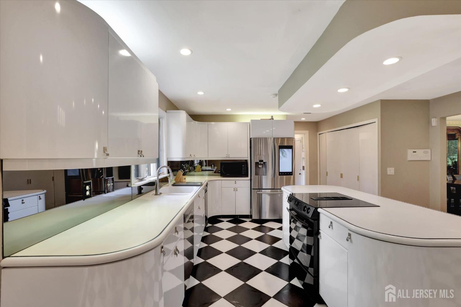 403 New Dover Road Colonia, NJ 07067 - Photo 15 of 51 a large white kitchen with a large island