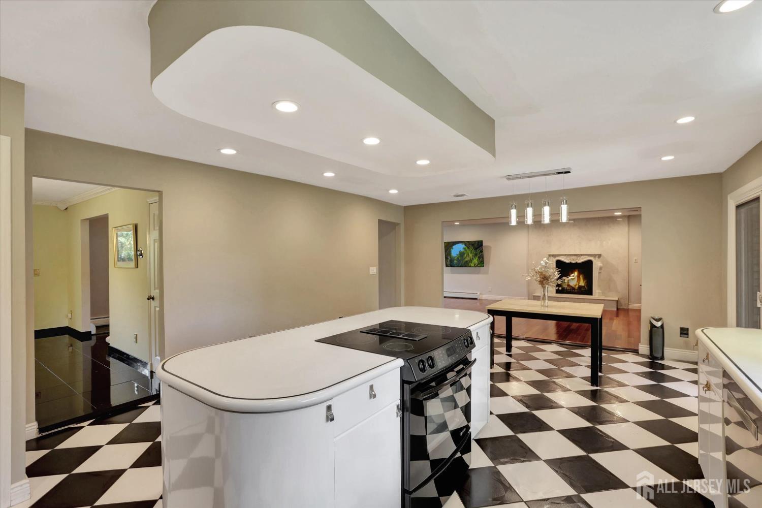 403 New Dover Road Colonia, NJ 07067 - Photo 16 of 51 a living room with a black white checkered floor with couches chair and a stove with wooden floor