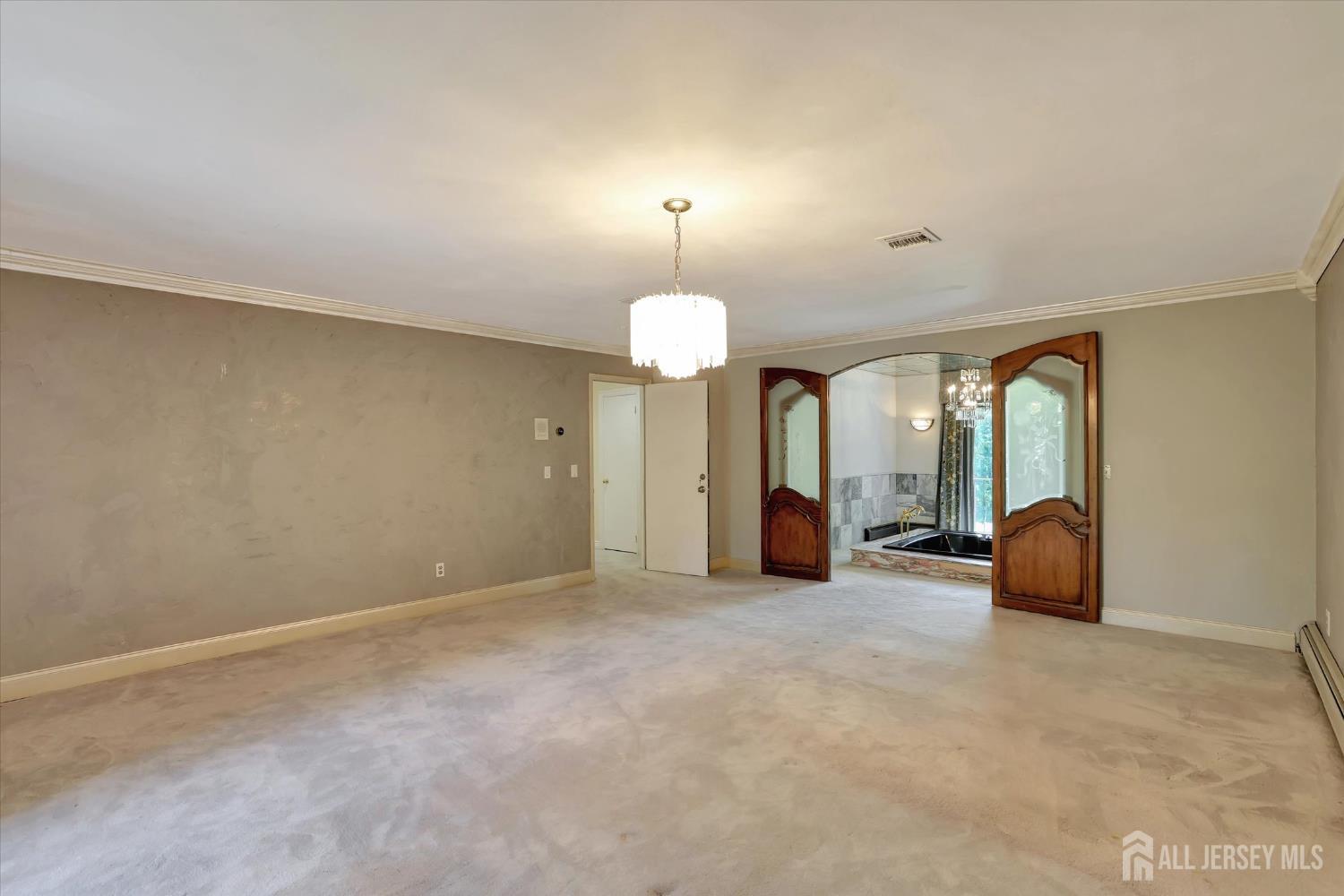 403 New Dover Road Colonia, NJ 07067 - Photo 24 of 51 an empty room with chandelier fan and windows