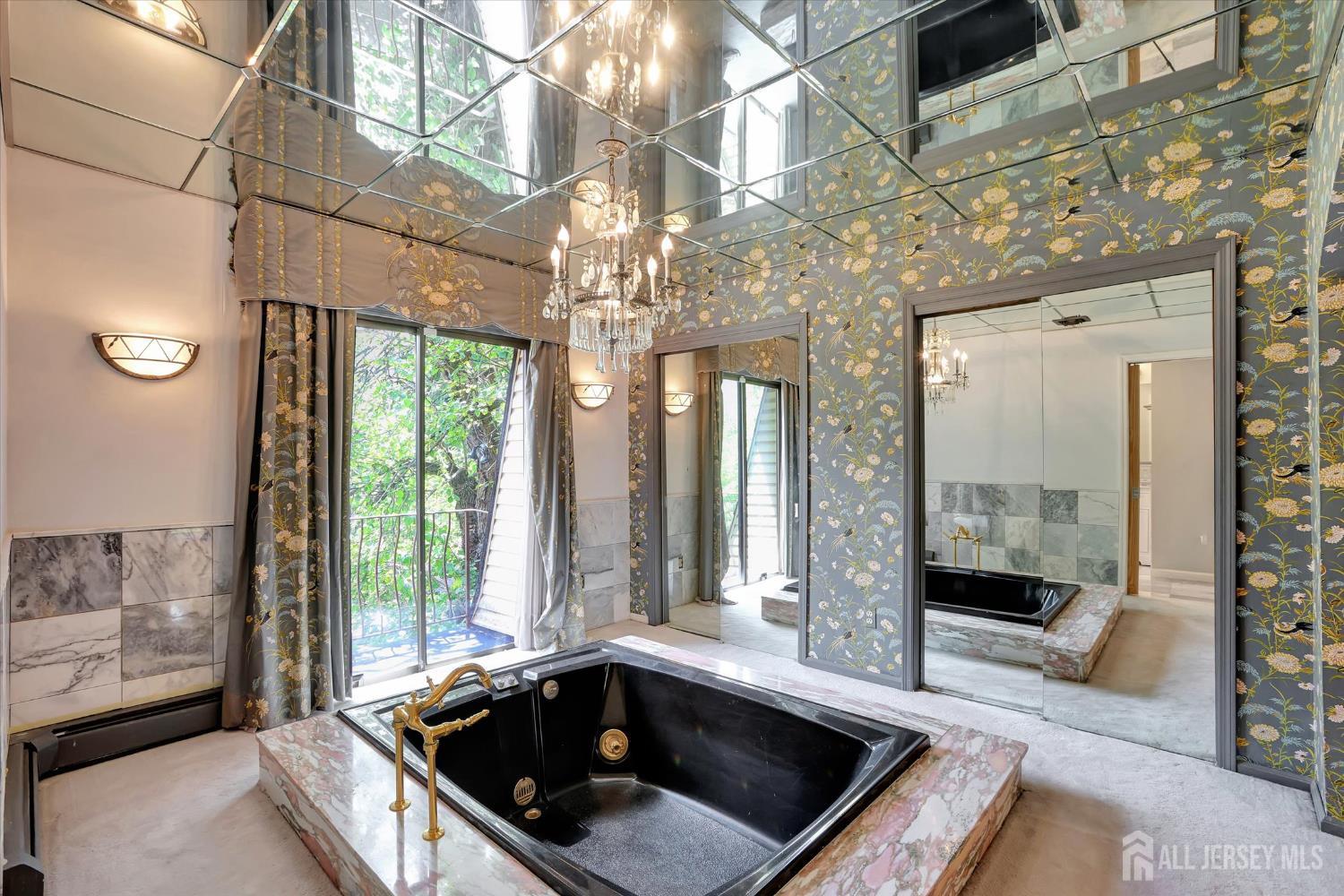 403 New Dover Road Colonia, NJ 07067 - Photo 26 of 51 a bathroom with a sink a large mirror and a bathtub