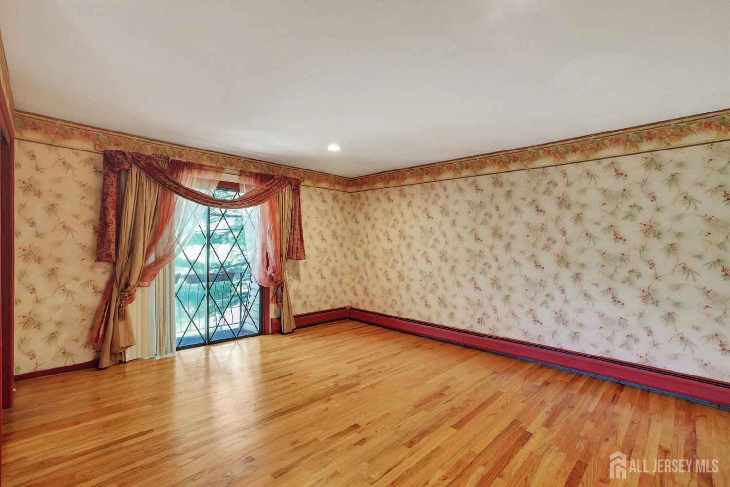 403 New Dover Road Colonia, NJ 07067 - Photo 29 of 51 a view of an empty room and wooden floor and a window