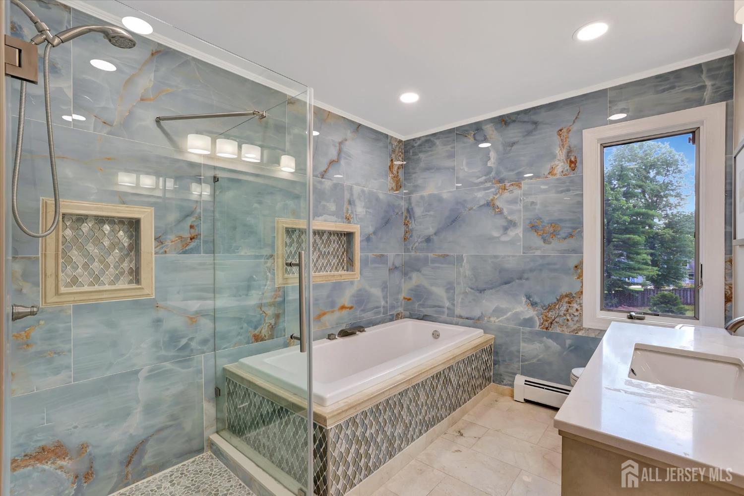 403 New Dover Road Colonia, NJ 07067 - Photo 31 of 51 a bathroom with a tub a sink and glass door shower