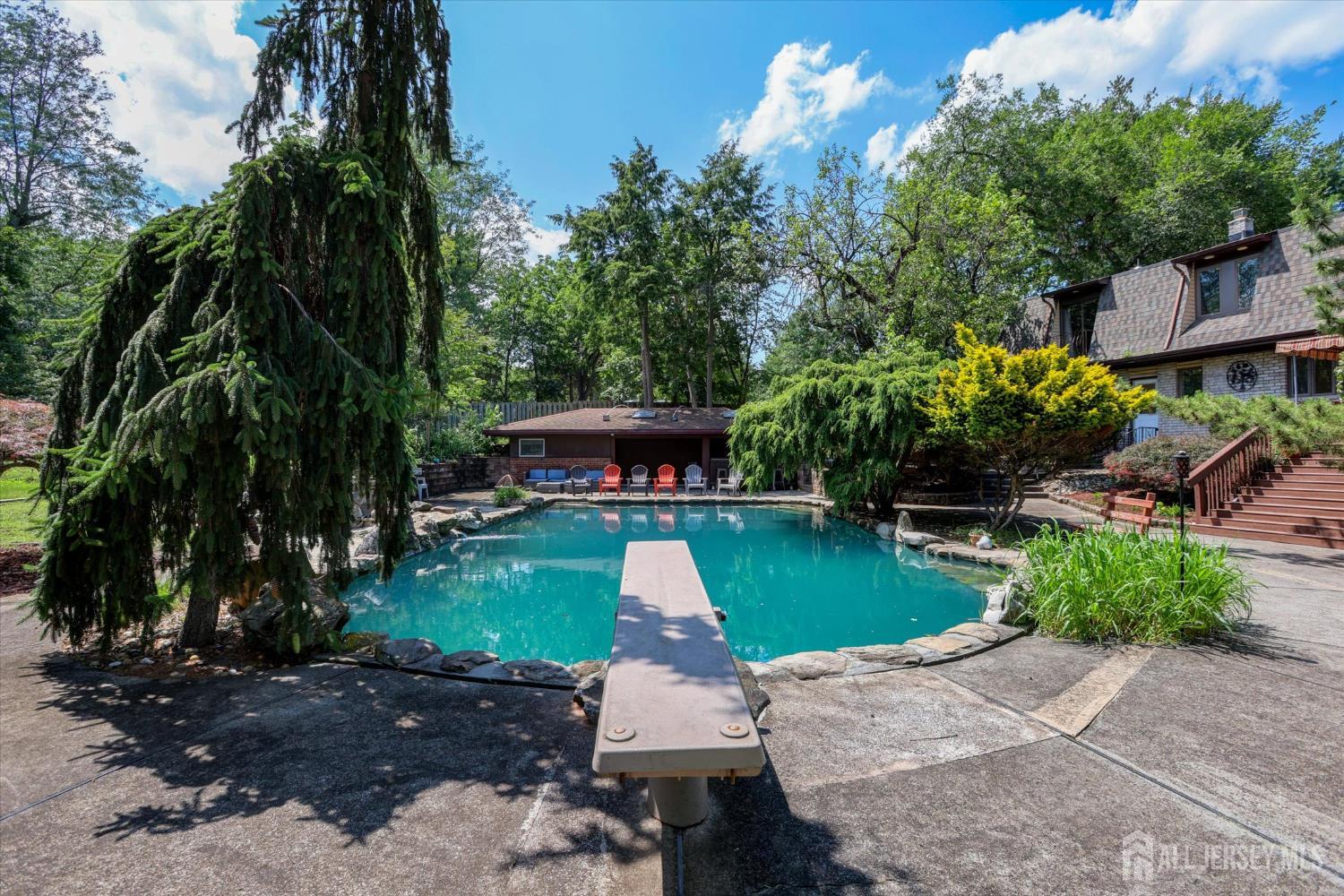 403 New Dover Road Colonia, NJ 07067 - Photo 43 of 51 a front view of a house with a yard and green space