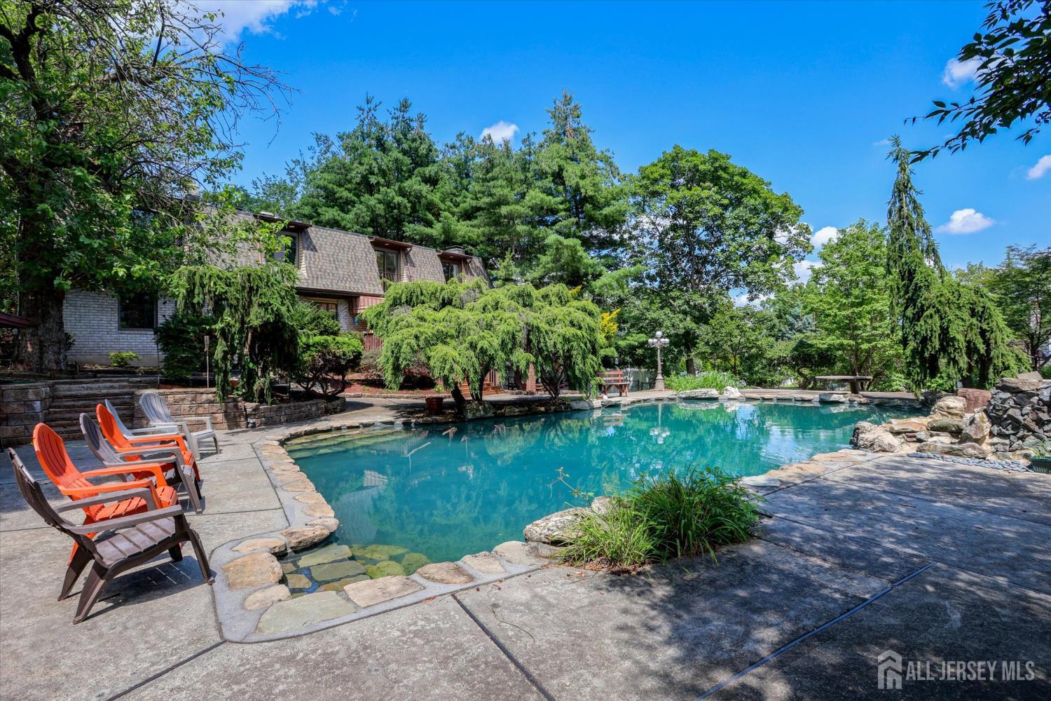 403 New Dover Road Colonia, NJ 07067 - Photo 45 of 51 a view of a backyard with plants and a lake