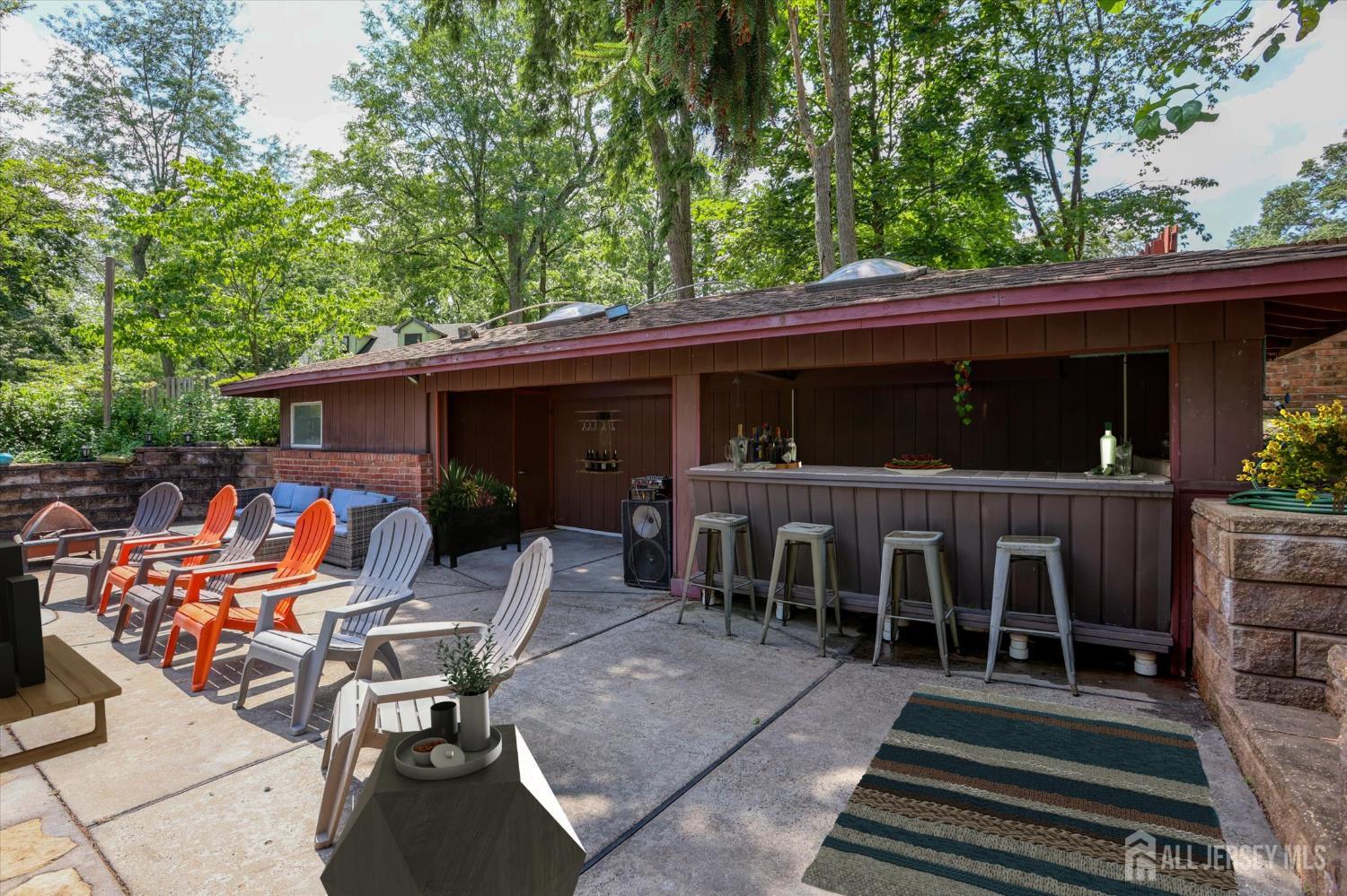403 New Dover Road Colonia, NJ 07067 - Photo 48 of 51 a view of a patio with table and chairs potted plants with wooden floor and fence