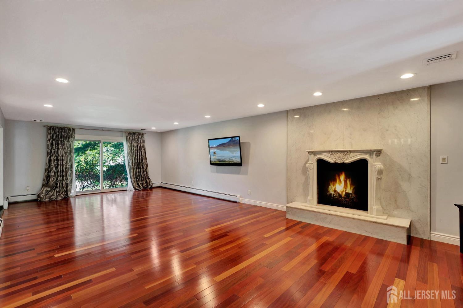 403 New Dover Road Colonia, NJ 07067 - Photo 9 of 51 a view of an empty room with wooden floor and a window