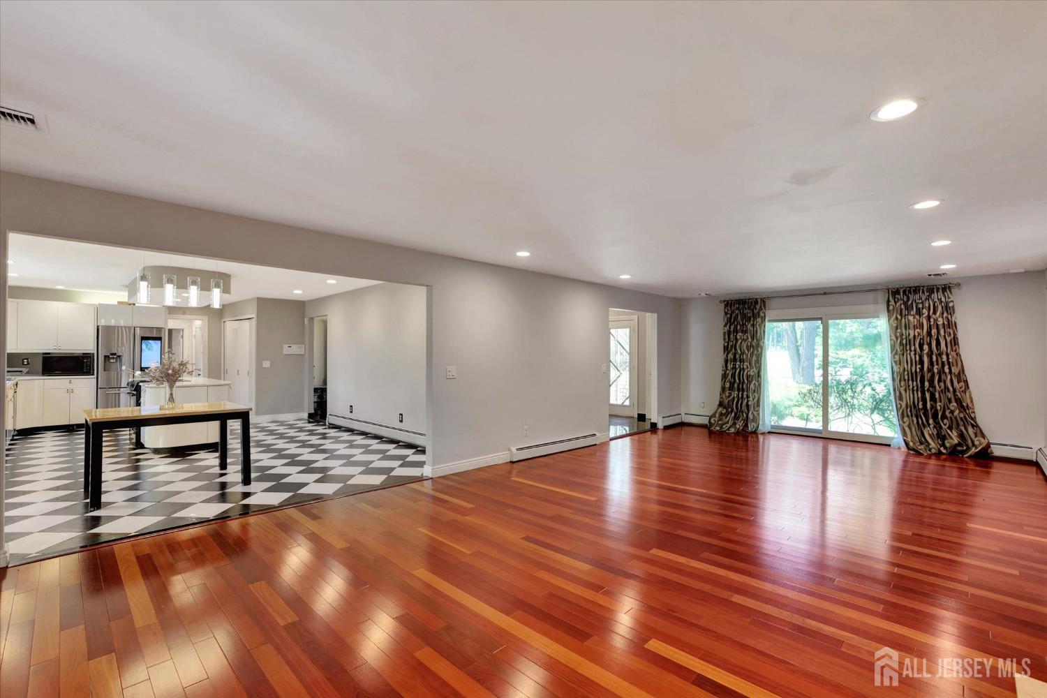 403 New Dover Road Colonia, NJ 07067 - Photo 10 of 51 a view of an empty room with window and wooden floor