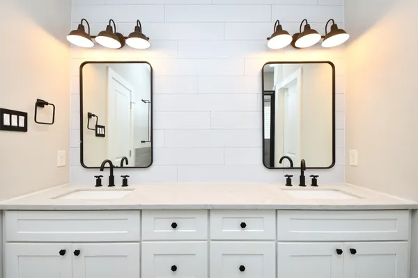 a bathroom with a sink mirror and vanity