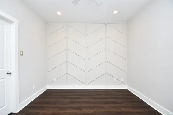a view of a room with wooden floor