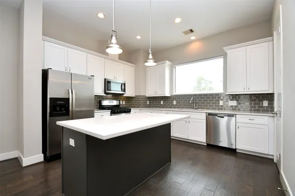 a kitchen with a refrigerator sink and microwave