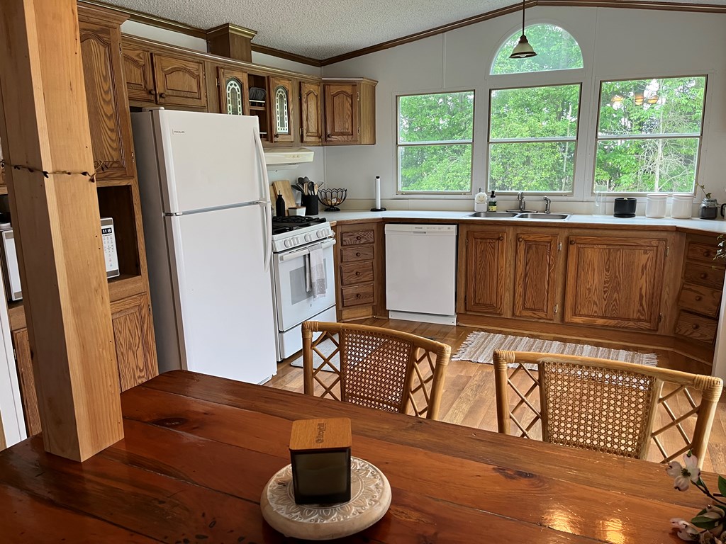23701 Range Road Union City, PA 16438 - Photo 11 of 33 a kitchen with stainless steel appliances granite countertop a refrigerator a sink a stove and a refrigerator with wooden floor