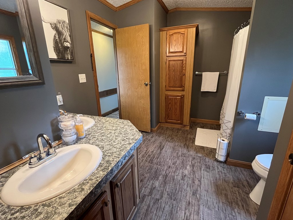 23701 Range Road Union City, PA 16438 - Photo 26 of 33 a bathroom with a granite countertop sink a mirror and a toilet