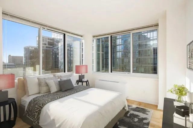 a bedroom with a large bed and a large window