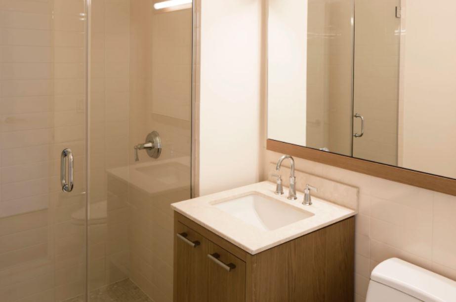 400 West 63rd Street, Unit 1702 Manhattan, NY 10069 - Photo 4 of 11 a bathroom with a sink a toilet and shower