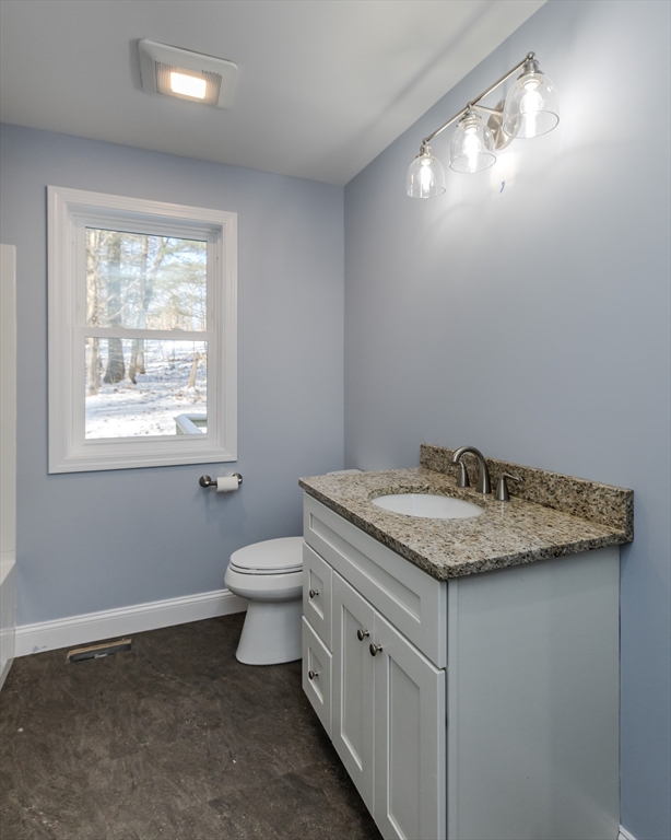 132 Kibbe Road East Longmeadow, MA 01028 - Photo 26 of 32 a bathroom with a granite countertop sink toilet and mirror