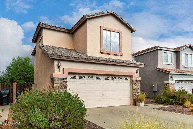 a front view of a house with a garage