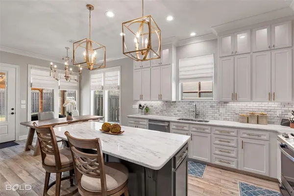 a kitchen with granite countertop a sink and cabinets