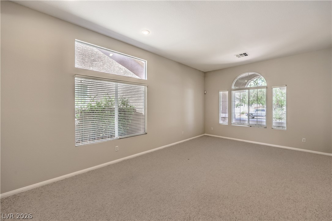 3713 Spring Shadow Road Las Vegas, NV 89129 - Photo 11 of 37 This ample living area features soft carpeting, recessed lighting, and multiple windows allowing abundant natural illumination.