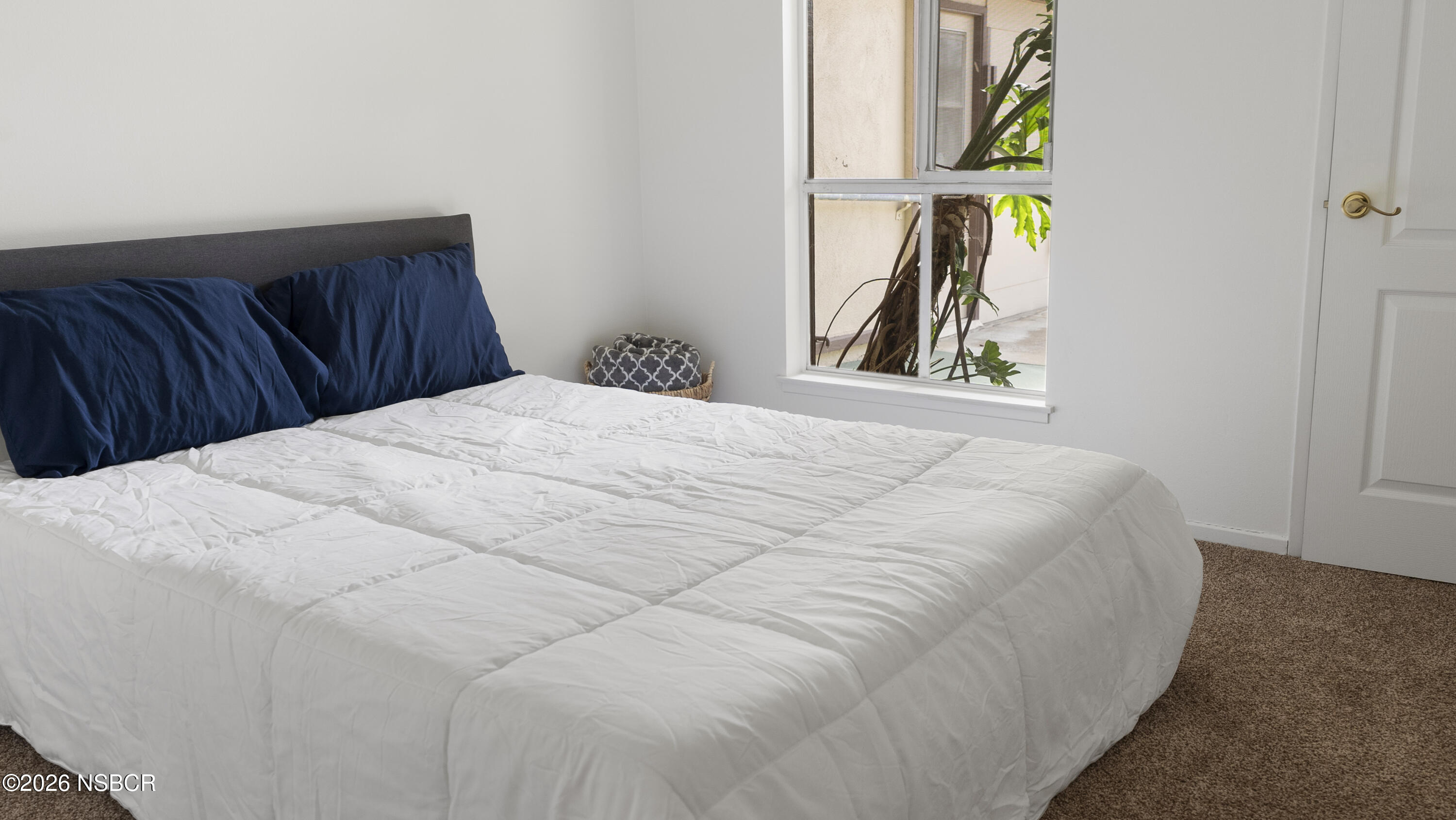 1312 North First Place Lompoc, CA 93436 - Photo 15 of 38 a bedroom with a bed and painting on the wall