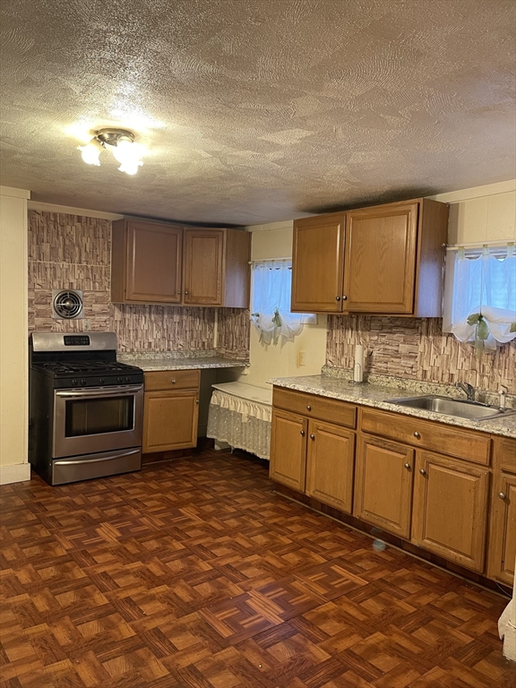 50 Chestnut Street Lynn, MA 01902 - Photo 12 of 13 a kitchen with granite countertop a sink stainless steel appliances and cabinets
