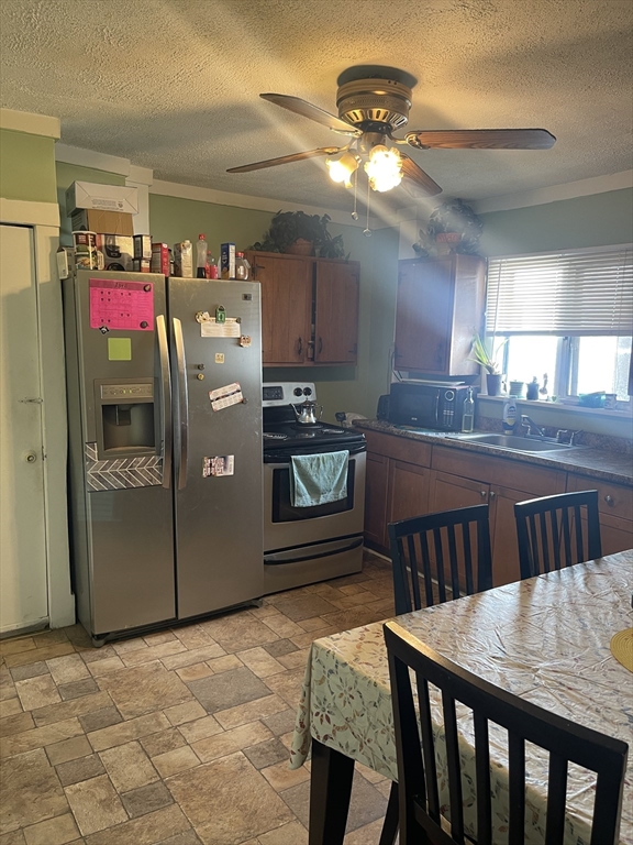 50 Chestnut Street Lynn, MA 01902 - Photo 7 of 13 a kitchen with refrigerator and cabinets