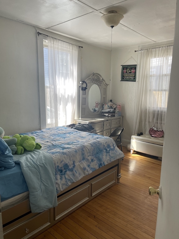 50 Chestnut Street Lynn, MA 01902 - Photo 8 of 13 a bedroom with a bed and wooden floor