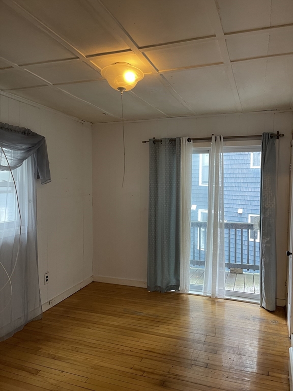 50 Chestnut Street Lynn, MA 01902 - Photo 9 of 13 an empty room with wooden floor and windows