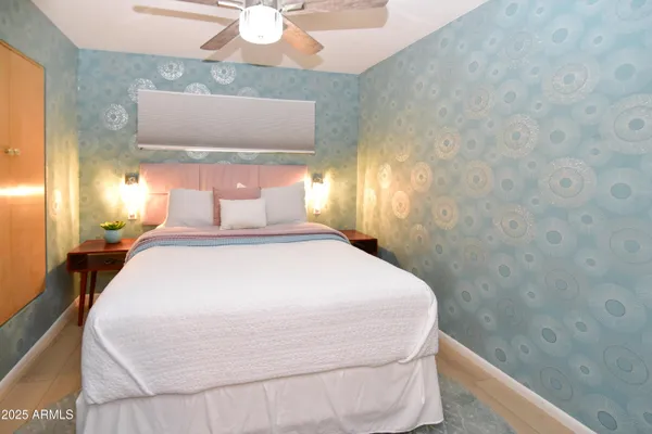 a bedroom with a bed and a chandelier