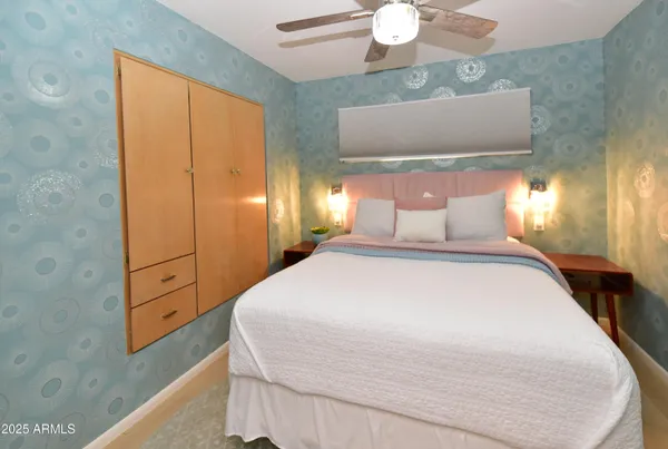 a bedroom with a bed and a hallway