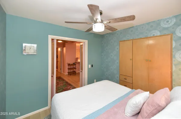 a bedroom with a bed and a chandelier