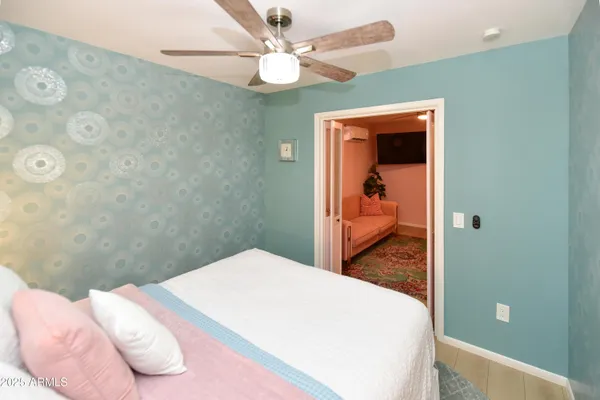 a bathroom with a sink and mirror with bathtub