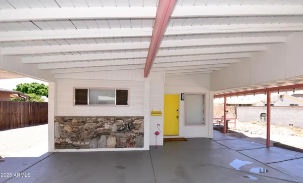 a living room with a fireplace and a floor to ceiling window