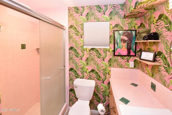 a bathroom with a sink and mirror with painted walls