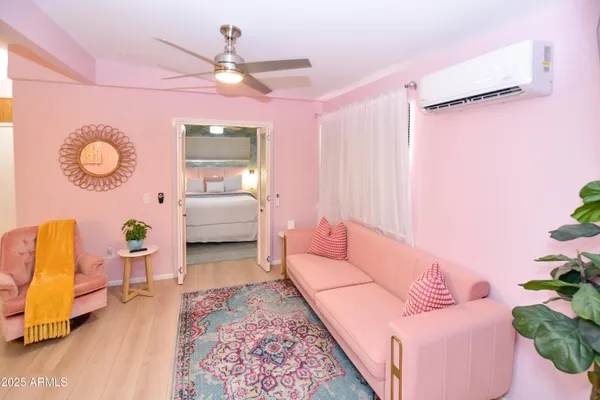 a living room with furniture and a wooden floor