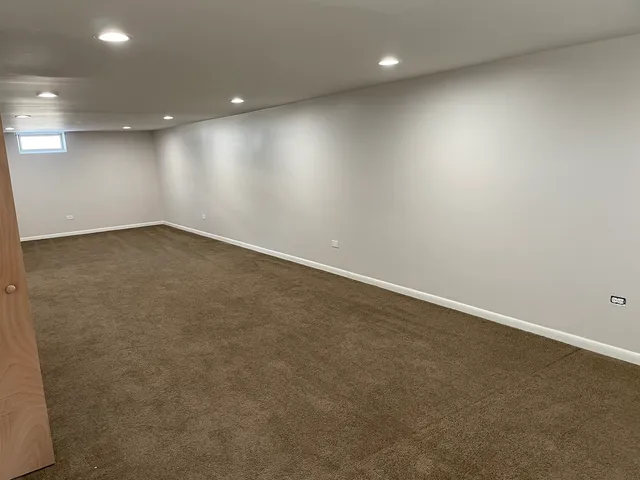 a white toilet sitting next to a bathroom sink