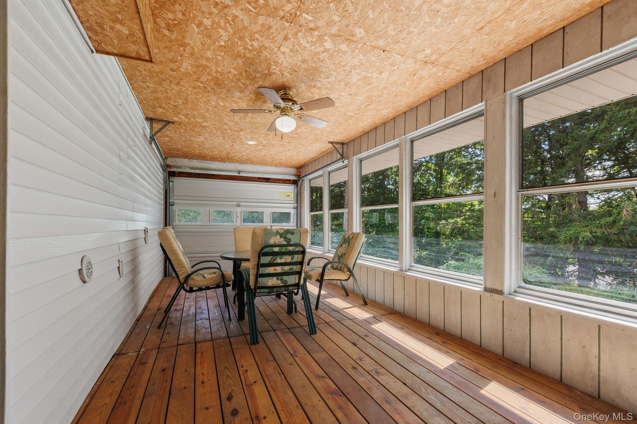 25 Harmony Road Brewster, NY 10509 - Photo 30 of 42 Sun room featured hardwood floors throughout, lots of windows and a garage door for a retro experience.