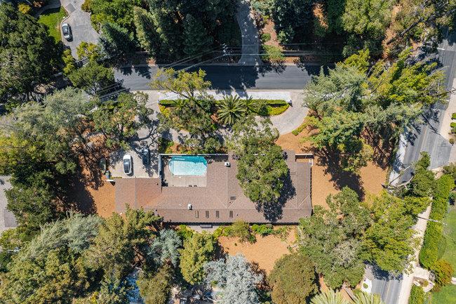 an aerial view of a house with a yard and garden