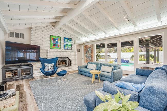 1 Edge Road Atherton, CA 94027 - Photo 16 of 33 a living room with furniture a flat screen tv and a fireplace