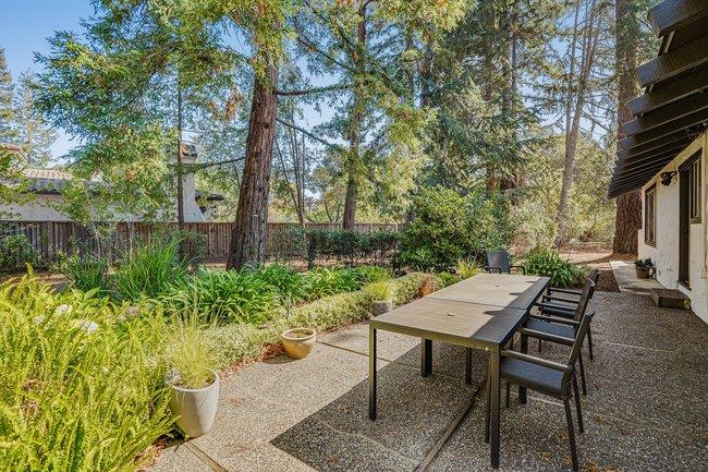 1 Edge Road Atherton, CA 94027 - Photo 32 of 33 a view of a backyard with table and chairs and potted plants