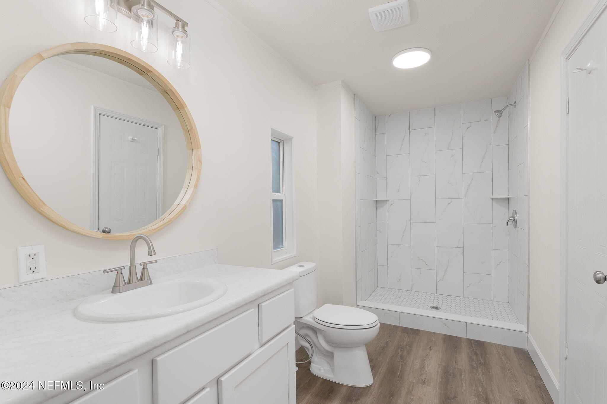 4526 Lambing Road Jacksonville, FL 32210 - Photo 11 of 32 a bathroom with a sink a toilet and a mirror