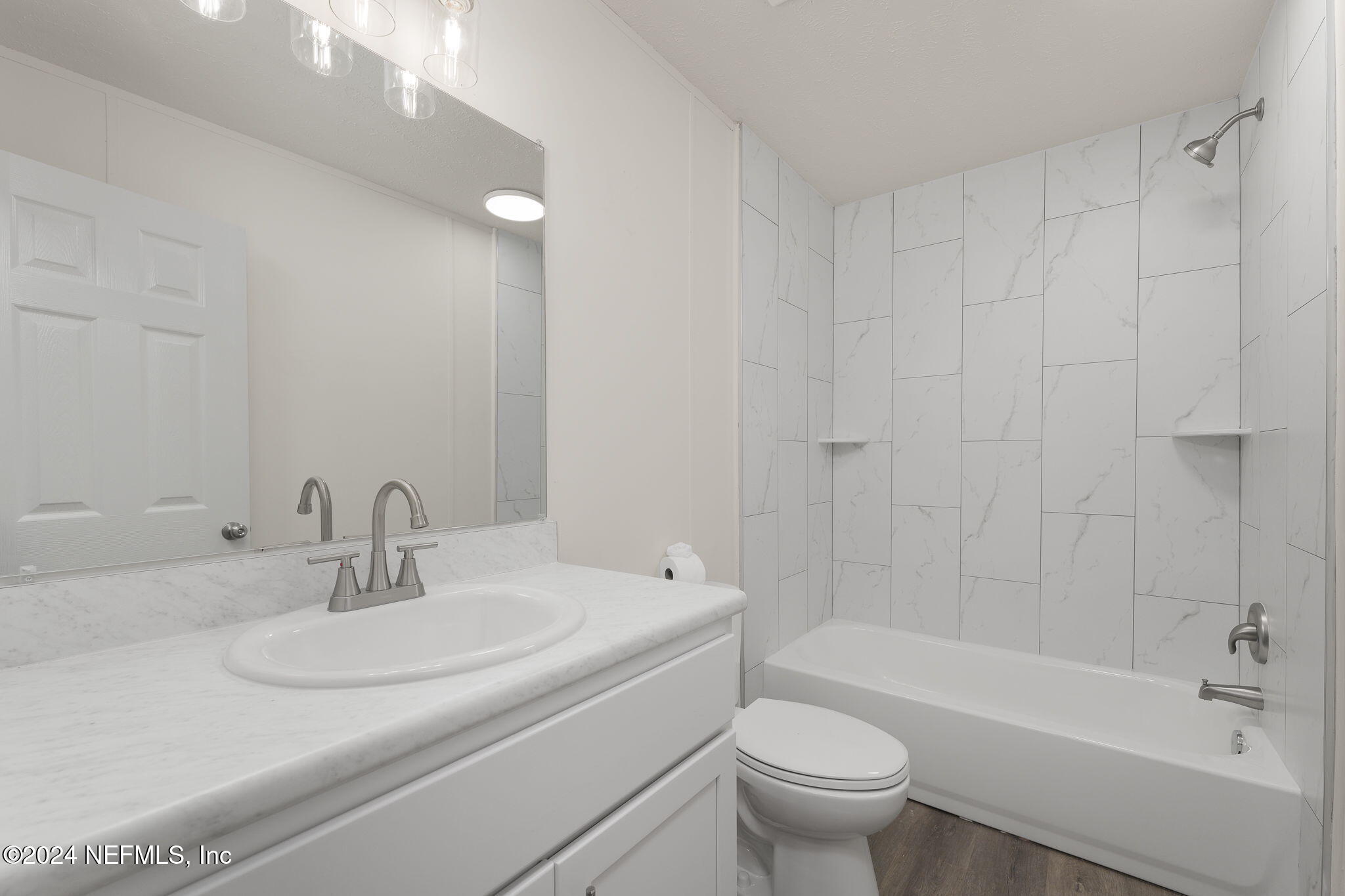 4526 Lambing Road Jacksonville, FL 32210 - Photo 18 of 32 a bathroom with a sink a toilet and a bathtub