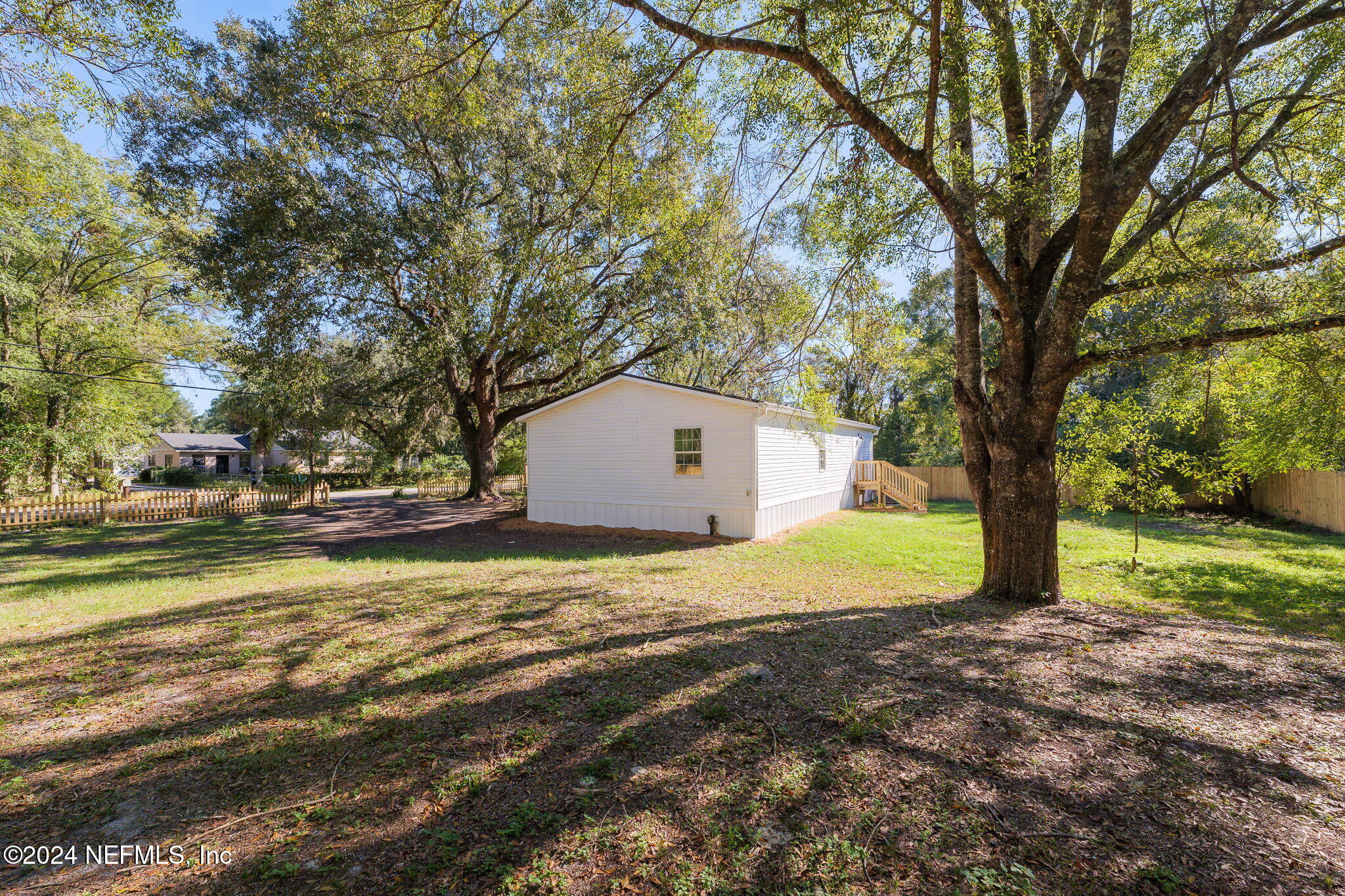 4526 Lambing Road Jacksonville, FL 32210 - Photo 25 of 32 a house with trees in front of it