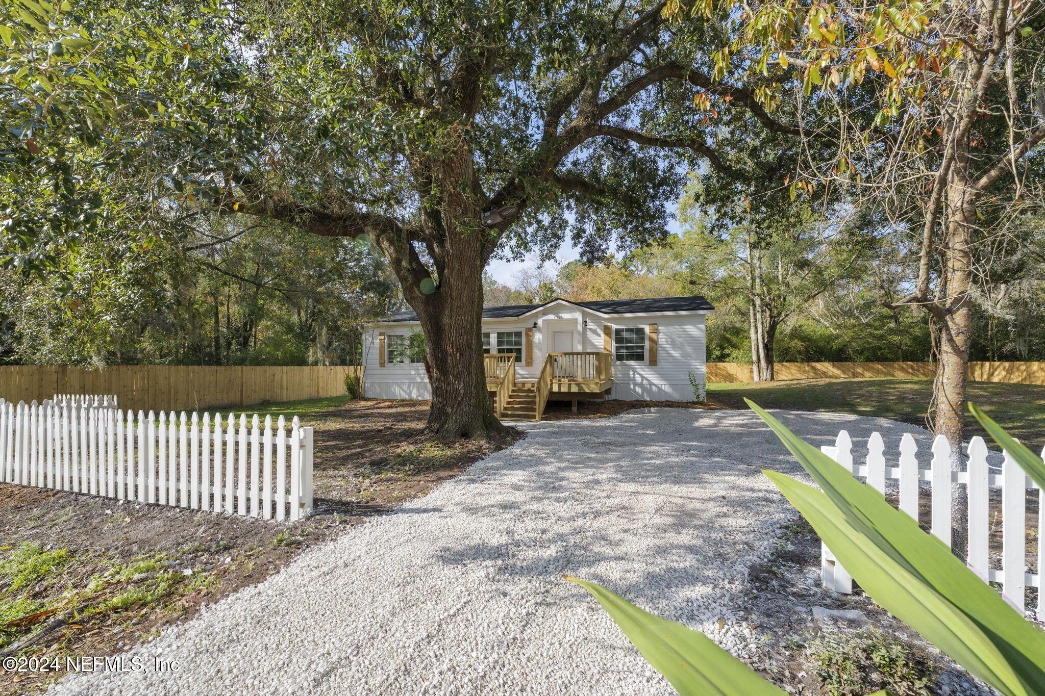 4526 Lambing Road Jacksonville, FL 32210 - Photo 27 of 32 a view of a house with backyard and a tree