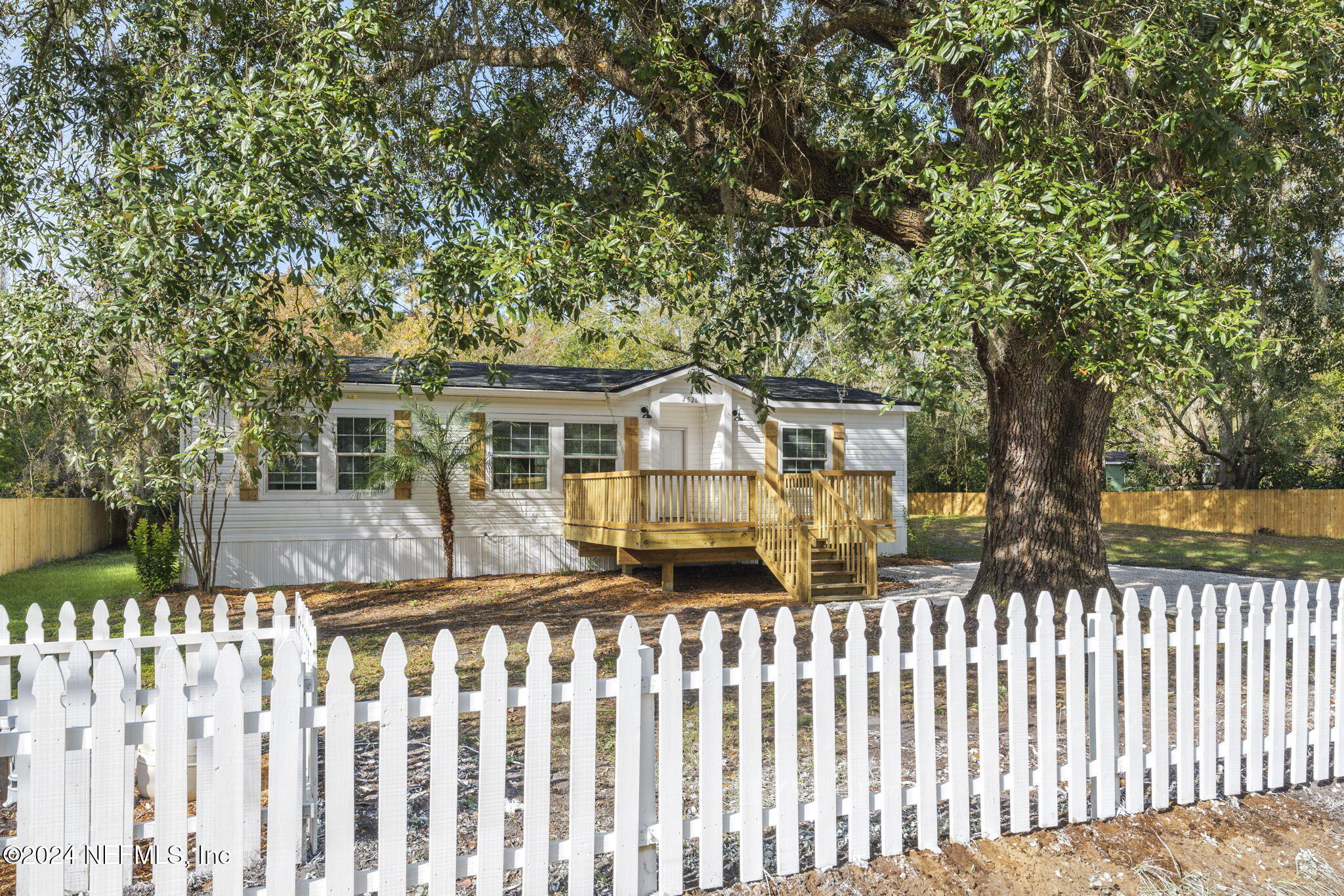 4526 Lambing Road Jacksonville, FL 32210 - Photo 29 of 32 a front view of house with wooden fence