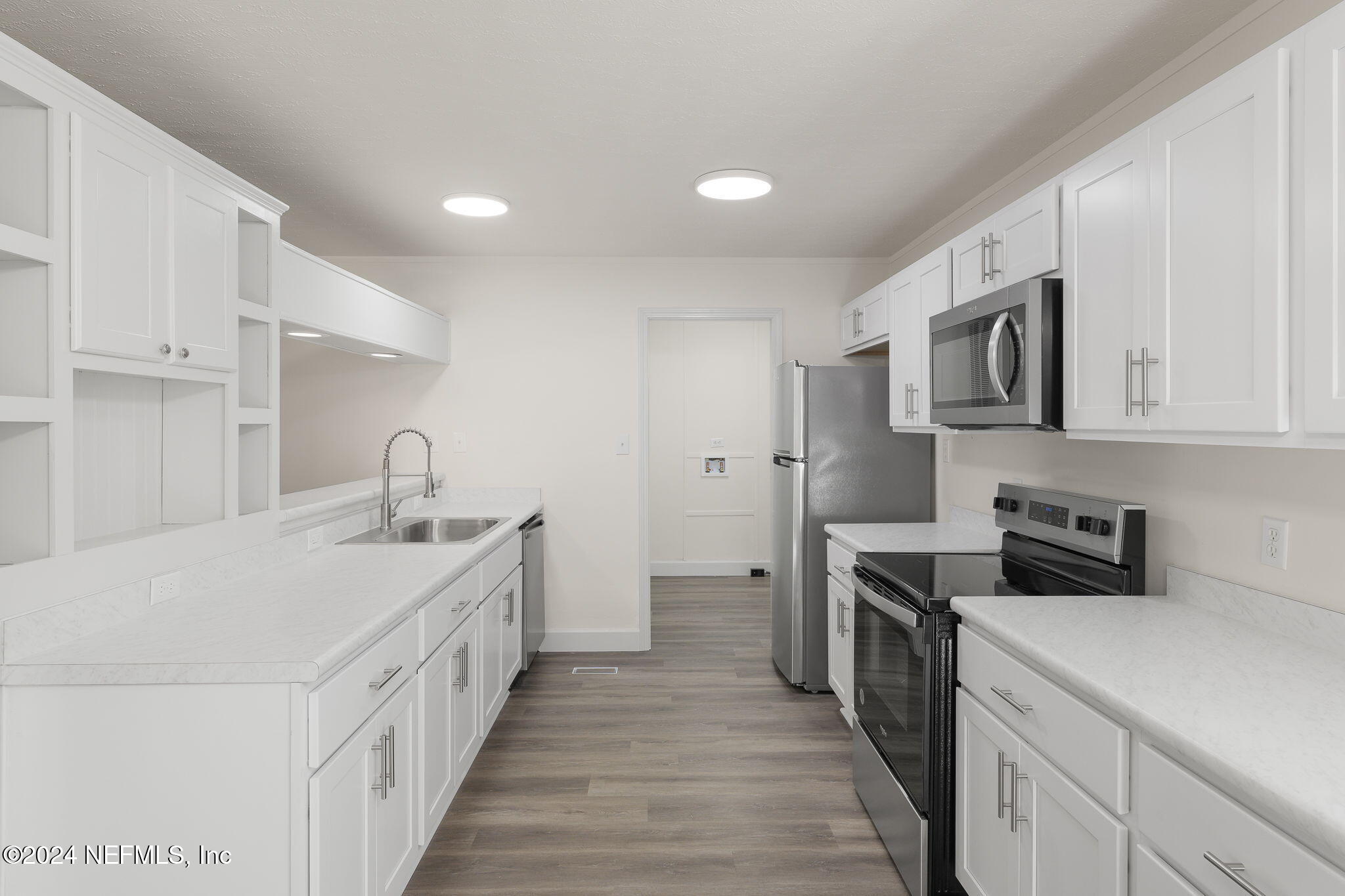 4526 Lambing Road Jacksonville, FL 32210 - Photo 4 of 32 a kitchen with sink a stove and refrigerator