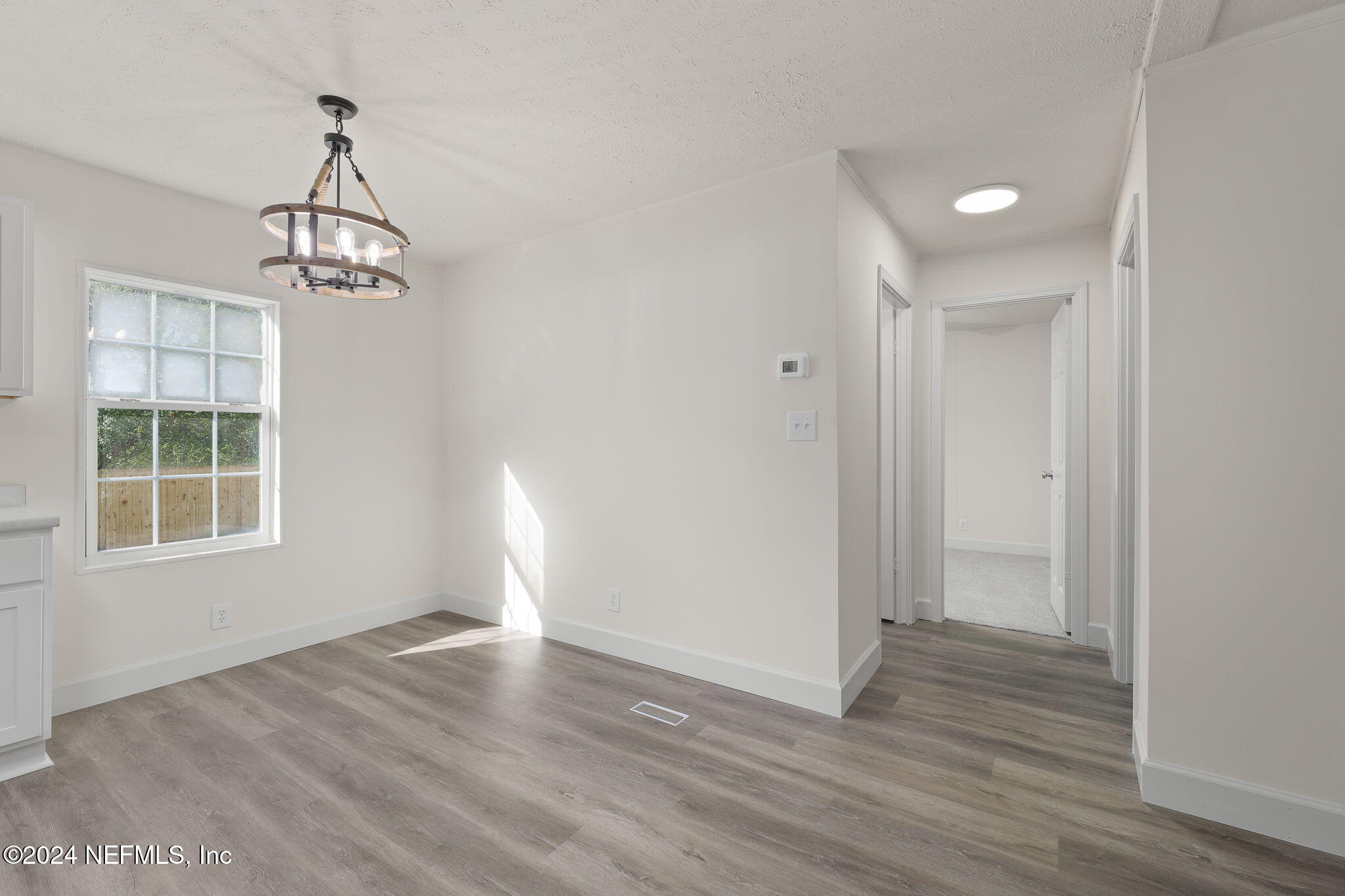 4526 Lambing Road Jacksonville, FL 32210 - Photo 8 of 32 a view of empty room with wooden floor and fan
