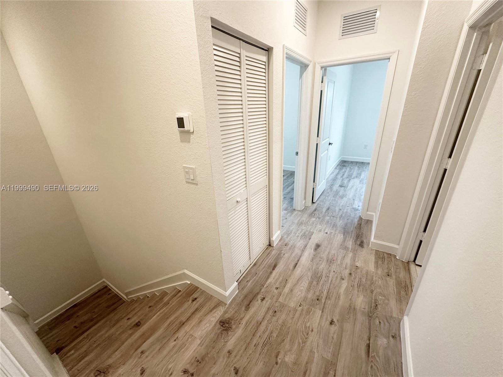 949 Northeast 211th Street Miami, FL 33179 - Photo 12 of 27 a view of a room with wooden floor and a window