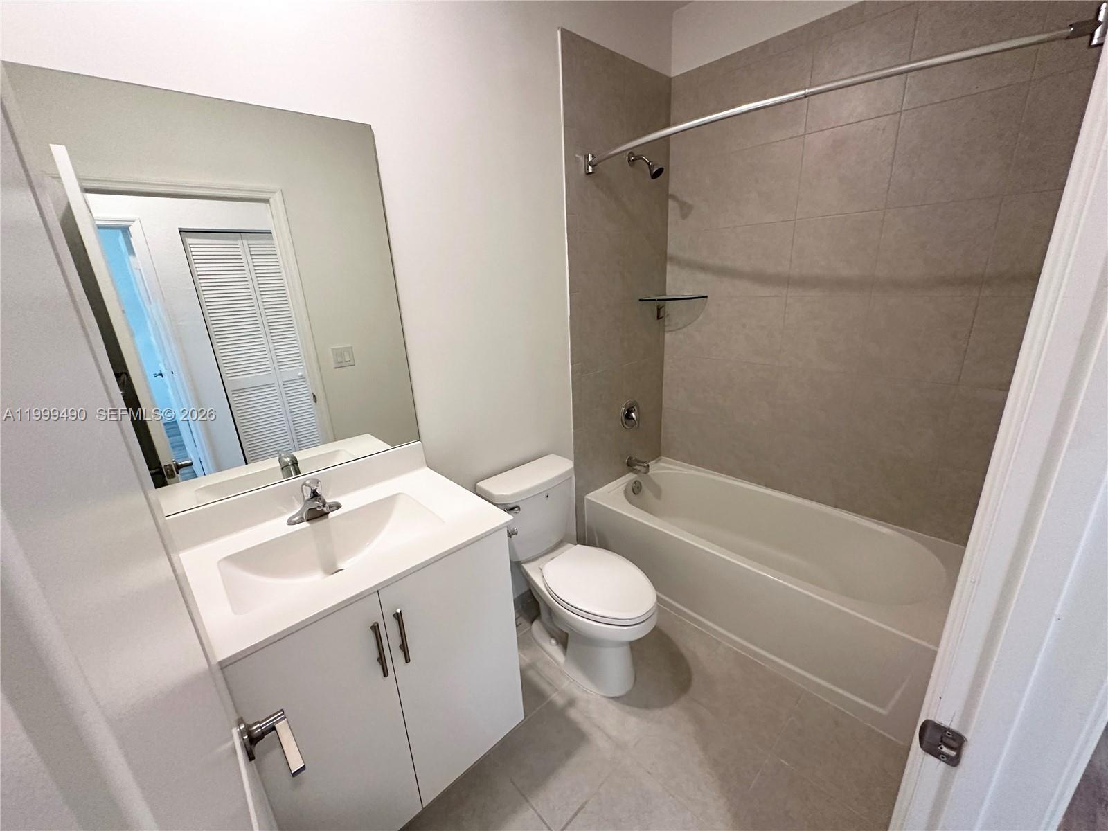 949 Northeast 211th Street Miami, FL 33179 - Photo 14 of 27 a bathroom with a sink toilet and shower